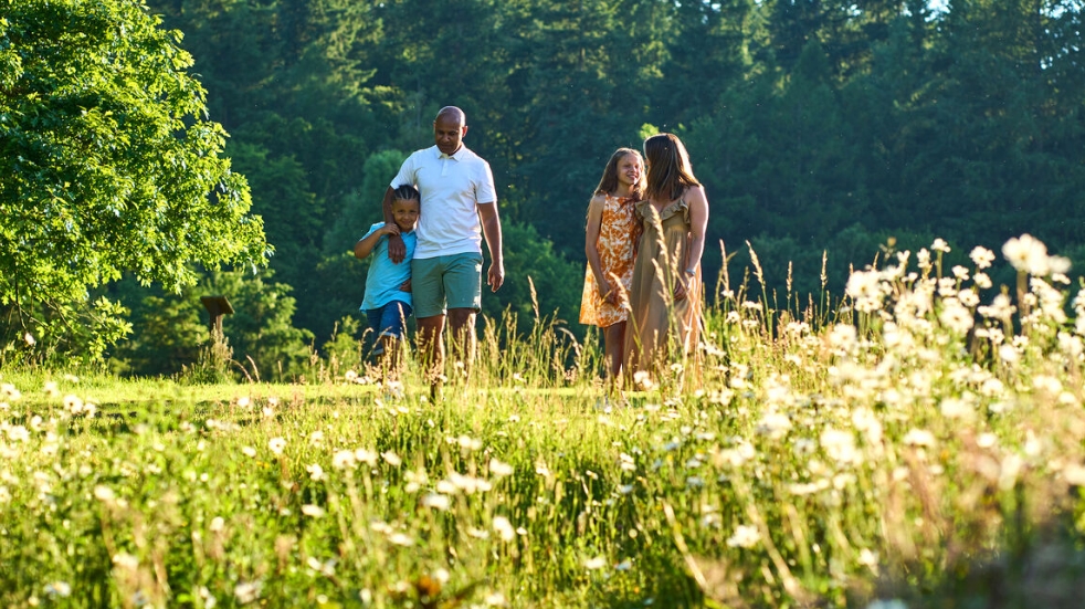 Family walking in a field at Whitemead